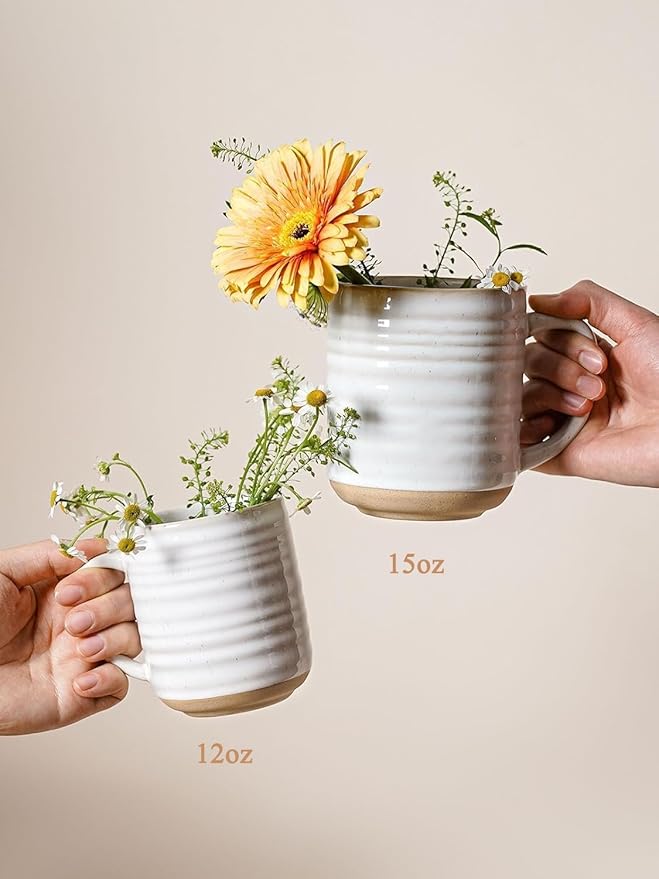 Arctic white ribbed ceramic mugs with handles, used as flower planters