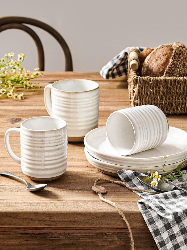Arctic white ribbed ceramic mug set with handles, some stacked on a plate