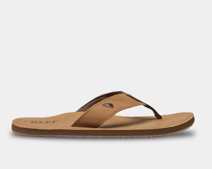 Reef Leather Smoothy Flip Flops in brown with soft leather straps and cushioned footbed, side view.