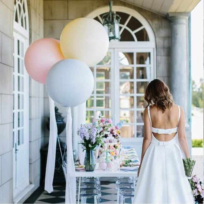 Pastel balloon cluster with pale pink, light blue, and white balloons