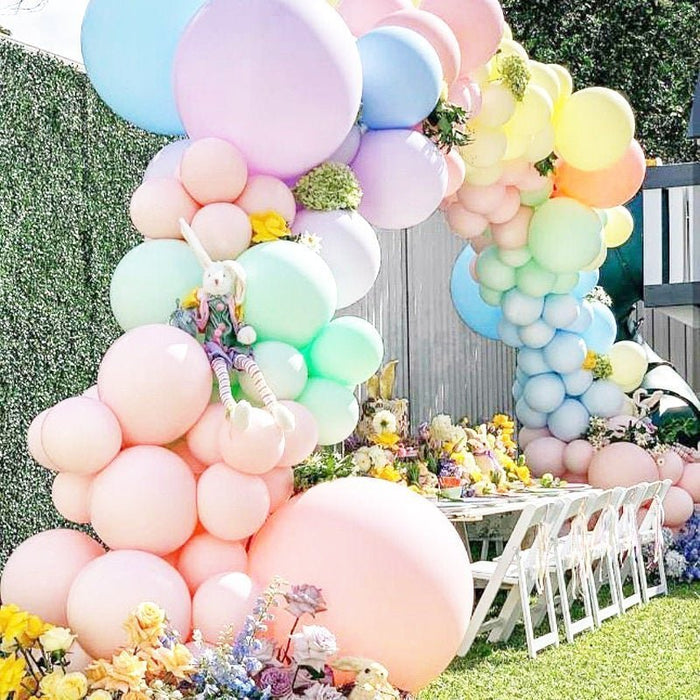 Pastel balloon arch with pink, blue, green, and cream balloons