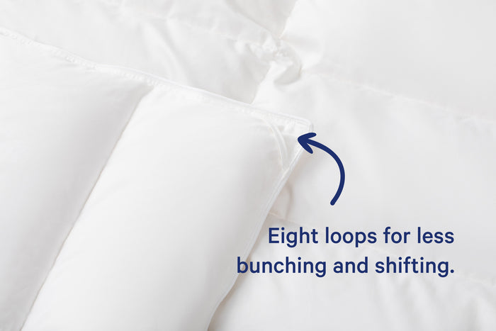 Close-up of the corner of the Down Duvet. Text on the image says "Eight loops for less bunching and shifting."