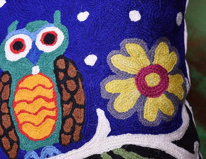 Blue embroidered wool pillow cover close-up of teal owl and yellow flower
