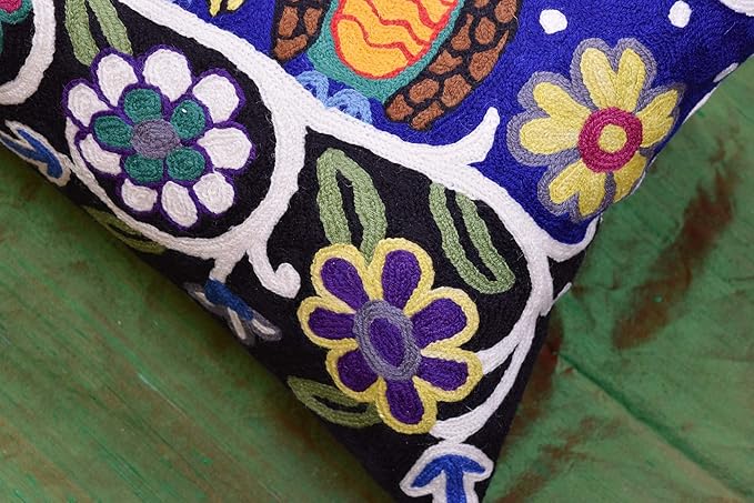 Blue embroidered wool lumbar pillow cover close-up of colorful flowers on white trim