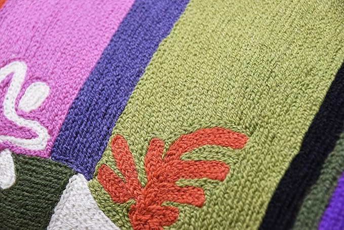 Close-up of lumbar pillow cover embroidery with green leaf panel and purple border