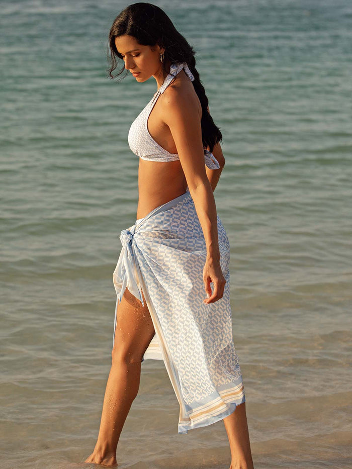 Model wearing the Elba bikini in blue geo   and sarong by NAIA Beach