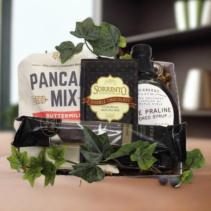 Breakfast gift basket with pancake mix, double chocolate mix, maple syrup bottle, and leaves