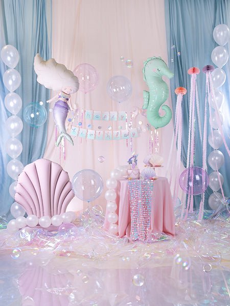 Mermaid balloon scene with hanging seahorse balloons in white, lavender, and mint colors
