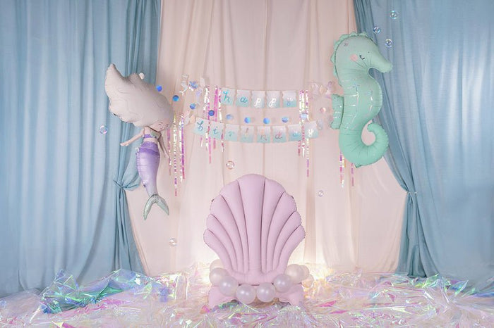Mermaid balloon backdrop with mint seahorse balloons and pink shell centerpiece