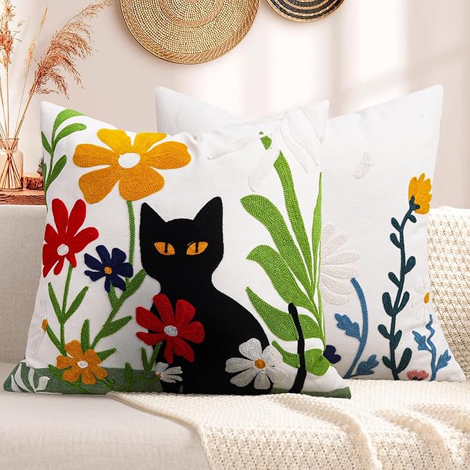 Embroidered square pillow cover with black cat illustration and bright flower stems