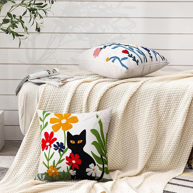 Square embroidered pillow cover with black cat motif and floral pattern on white