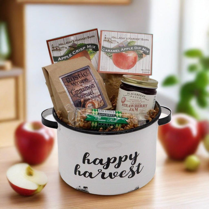 Happy harvest gift basket in white enamel bucket with food mixes and jam jar, apples