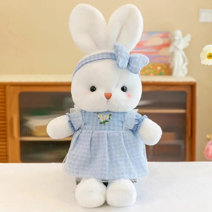 Blue bunny plush doll wearing a light blue dress with bow headband and flower patch