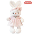 Pink bunny plush doll with bow headband and ruffled dress with flower embroidery