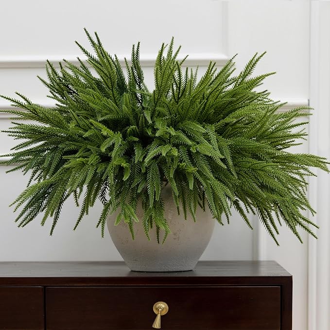 Artificial Norfolk pine branches arranged in a vase