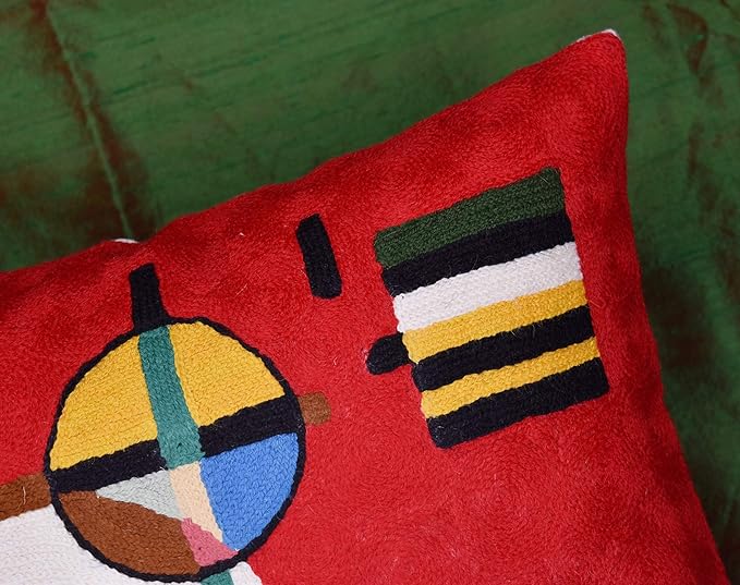Red wool throw pillow cover corner detail with large circle and stripe accents