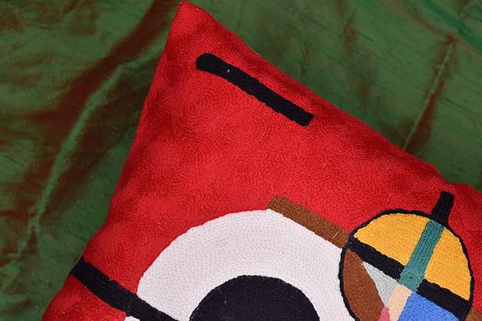 Red wool throw pillow cover close-up of embroidered bars and partial circular form