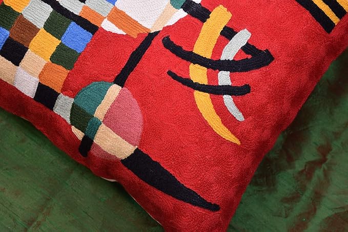 Red embroidered wool pillow cover close-up of colorful arches and checkered blocks