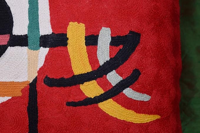 Red embroidered wool throw pillow cover close-up of curved stripe shapes in yellow and white