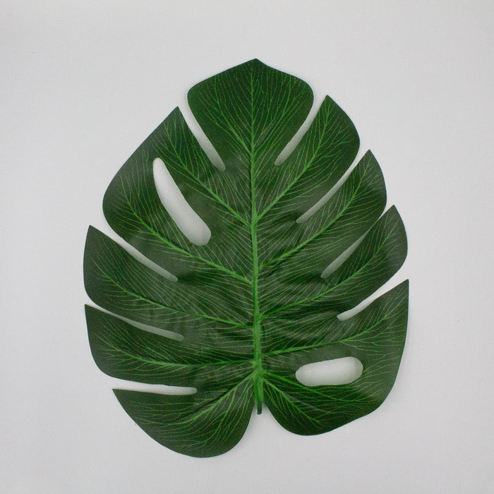 Monstera leaf cutout decoration, dark green with white slit cutouts