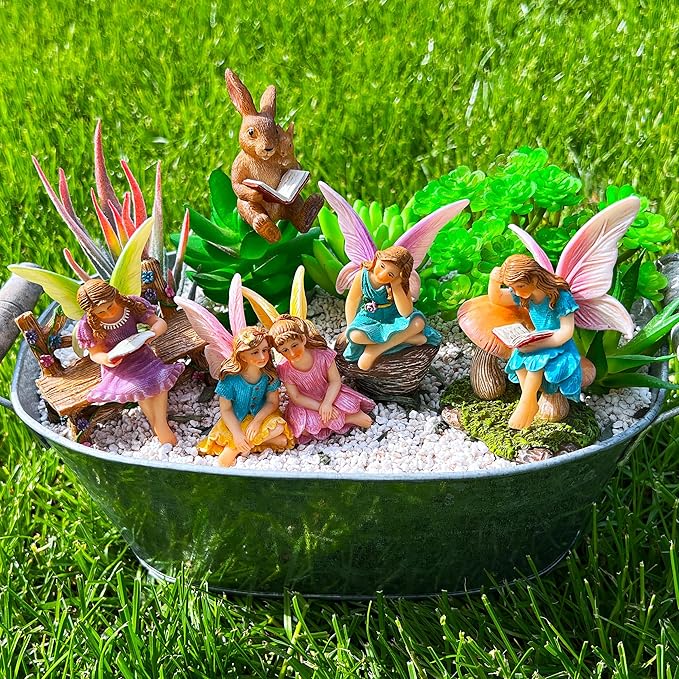 Miniature fairy figurines set in round tray with gravel, fairies reading and a bunny statue
