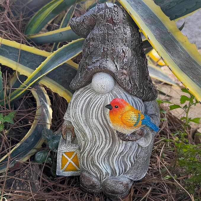 Garden gnome figurine, orange bird on swirled robe with star lantern at side.