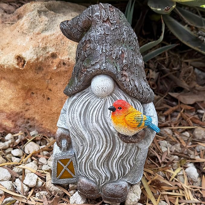Garden gnome figurine with orange bird perched on swirled robe and star lantern.