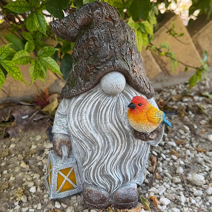 Garden gnome figurine with orange bird perched on gray swirled robe and lantern.