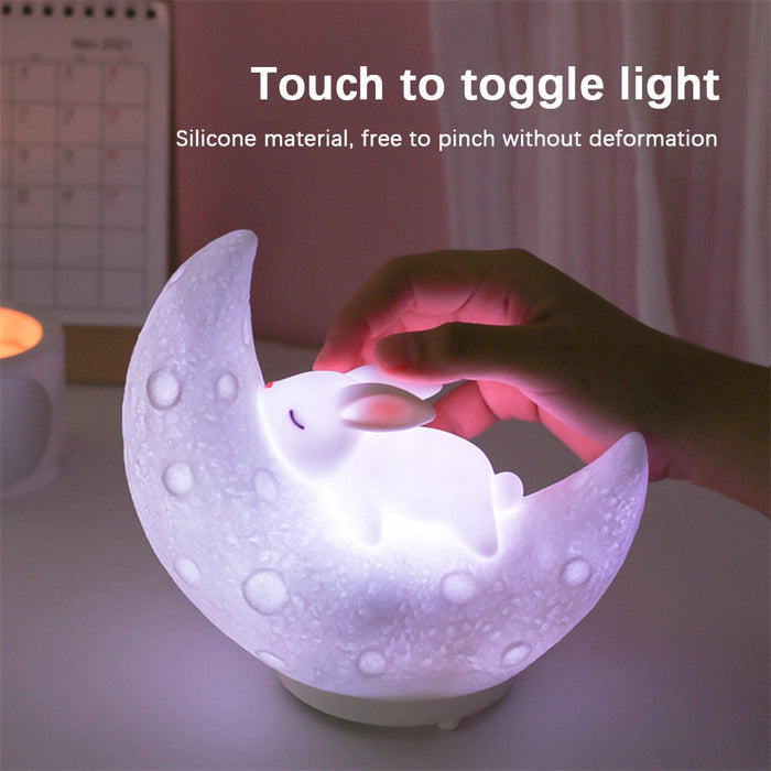 White moon bunny night light speaker with glowing touch area and speaker grille detail