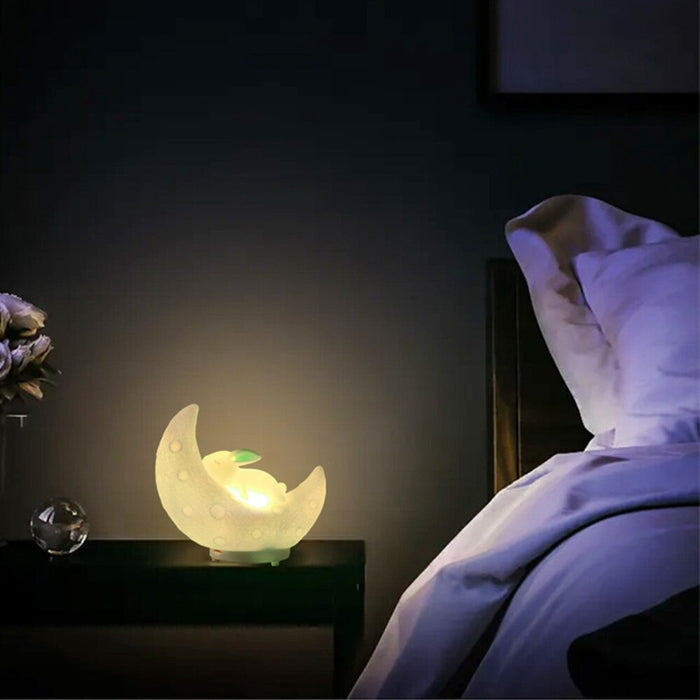White moon bunny night light speaker casting a warm glow from its crescent body