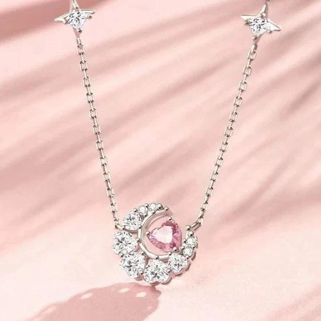 Silver-tone pendant necklace with star charms and a pink zircon heart centerpiece