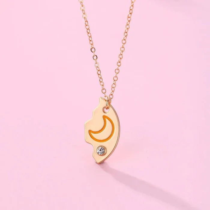 Friendship necklace with gold sun-and-moon pendant on a gold-tone chain, with clear crystals