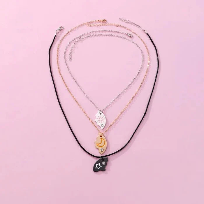 Friendship necklace set with sun, moon, and star pendants on black and gold chains