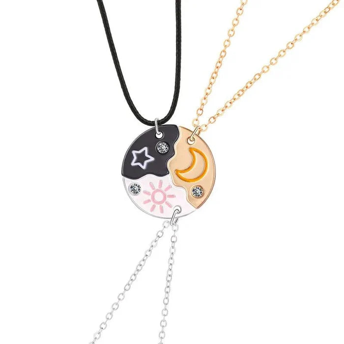 Friendship necklace with dark star pendant and gold moon pendant on black and gold-tone chains