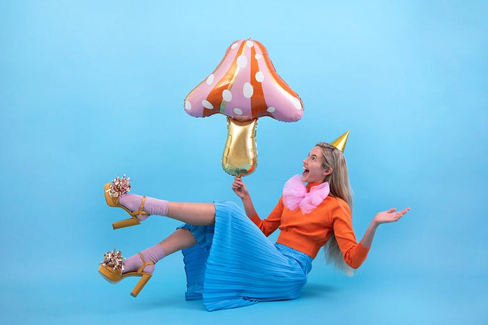 Mushroom-shaped balloon with gold stem and orange polka-dot cap
