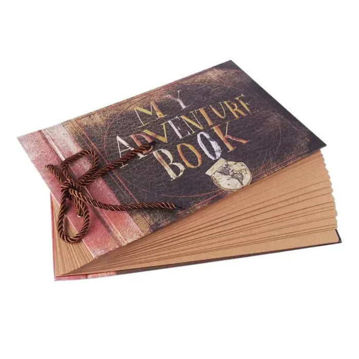 Adventure scrapbook album with stacked pages, dark cover and gold “MY ADVENTURE BOOK” title.