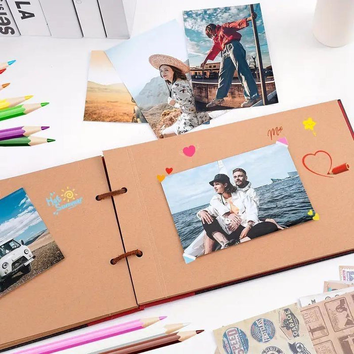 Vintage adventure scrapbook album open with photo panels and decorative heart stickers.