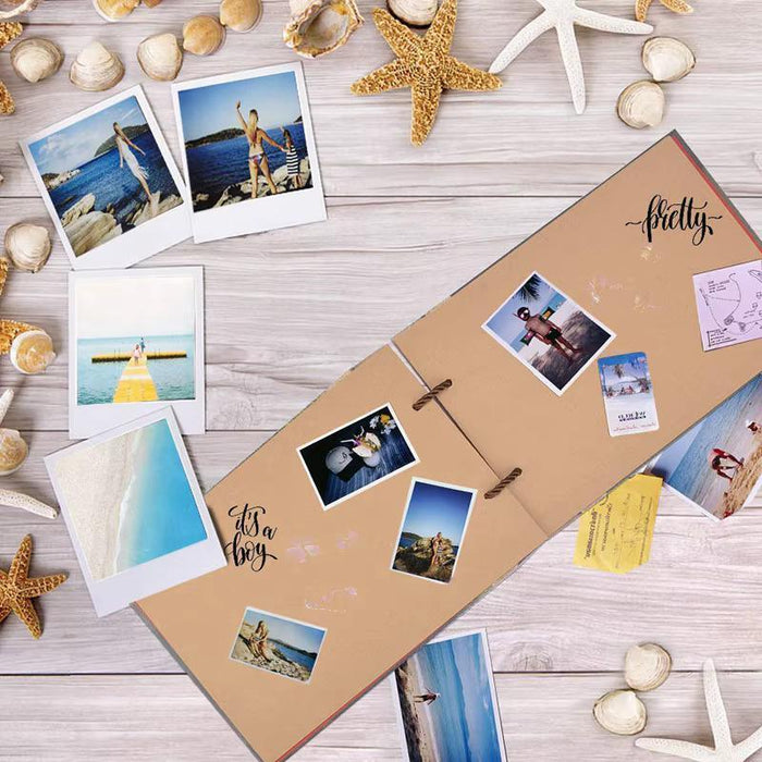 Adventure scrapbook album laying flat with multiple photo snapshots attached to tan pages.