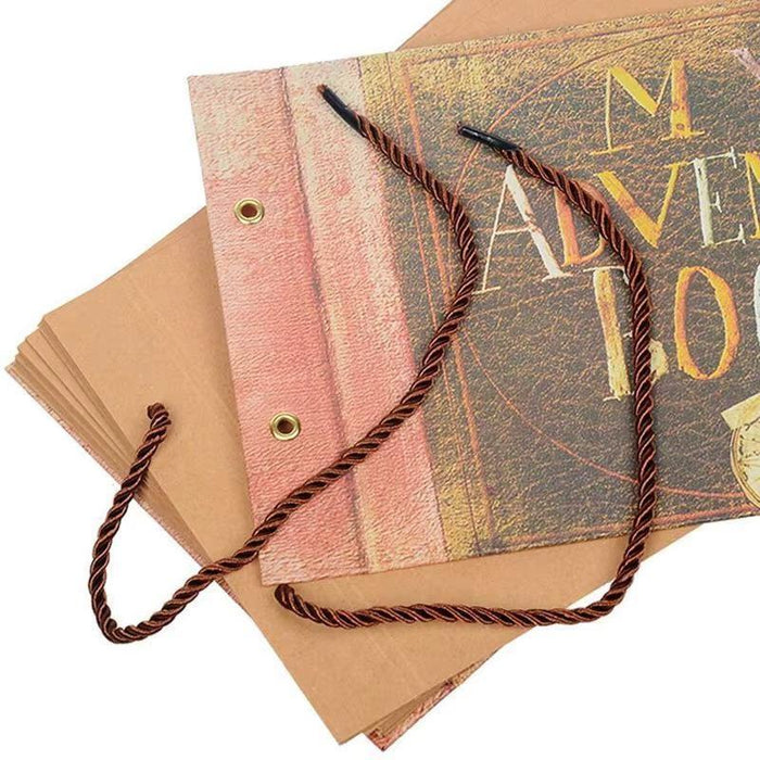Close-up of adventure scrapbook cover spine and rope tie; gold “MY ADVENTURE BOOK” text.