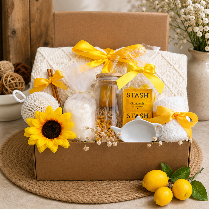 Brown gift box with yellow ribbon, sunflowers, tea candle set, and STASH jars