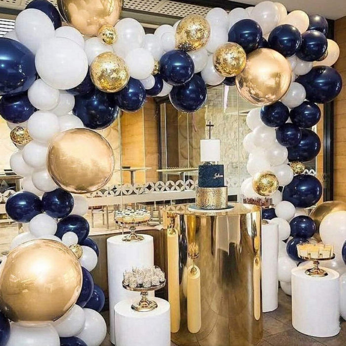 Navy, white, and gold balloon garland arch with mixed large and small balloons