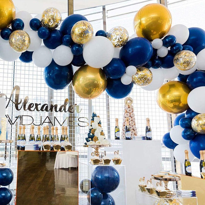 Navy and white balloon garland with gold accent balloons in a curved arch