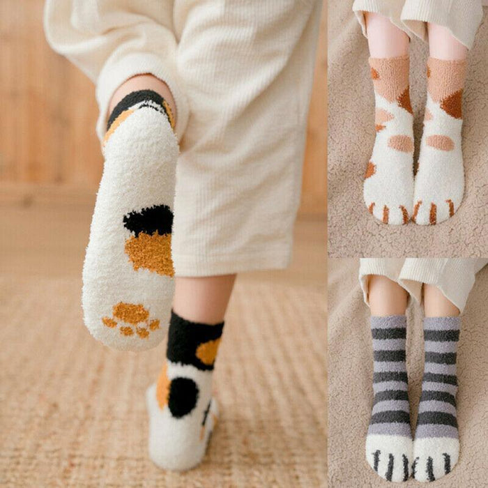 Cat-face crew socks with white base, black and brown spots, and paw-print details
