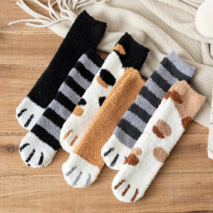 Four pairs of cat-themed crew socks laid flat: striped, cat-face, and paw patterns