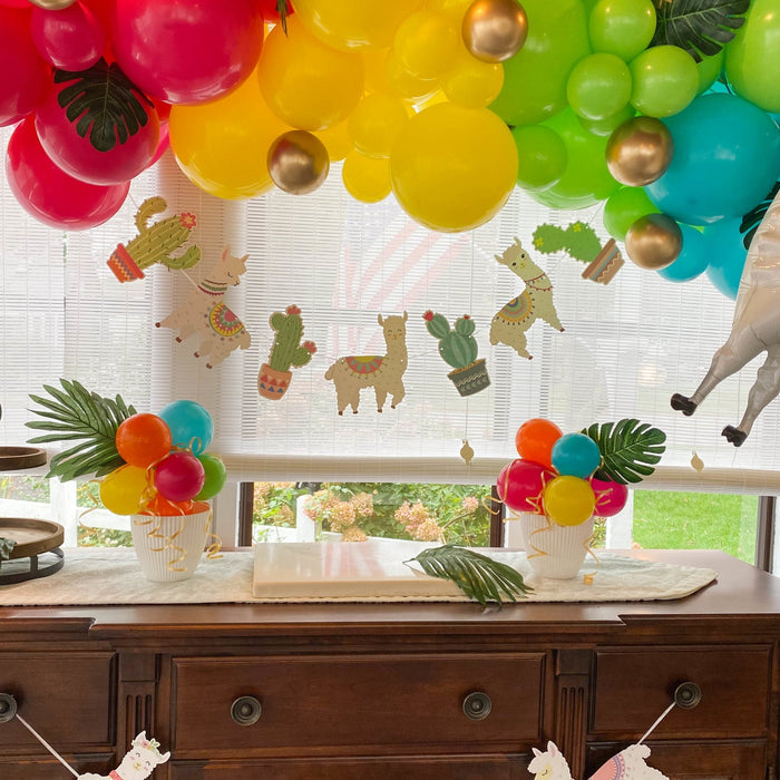 Neon tropical balloon garland with colorful clusters and cactus-themed balloons