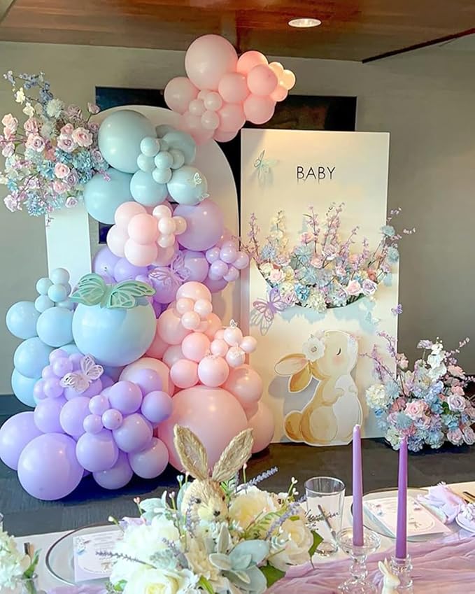 Pastel balloon arch garland in pink, lilac, and blue with stacked balloon clusters