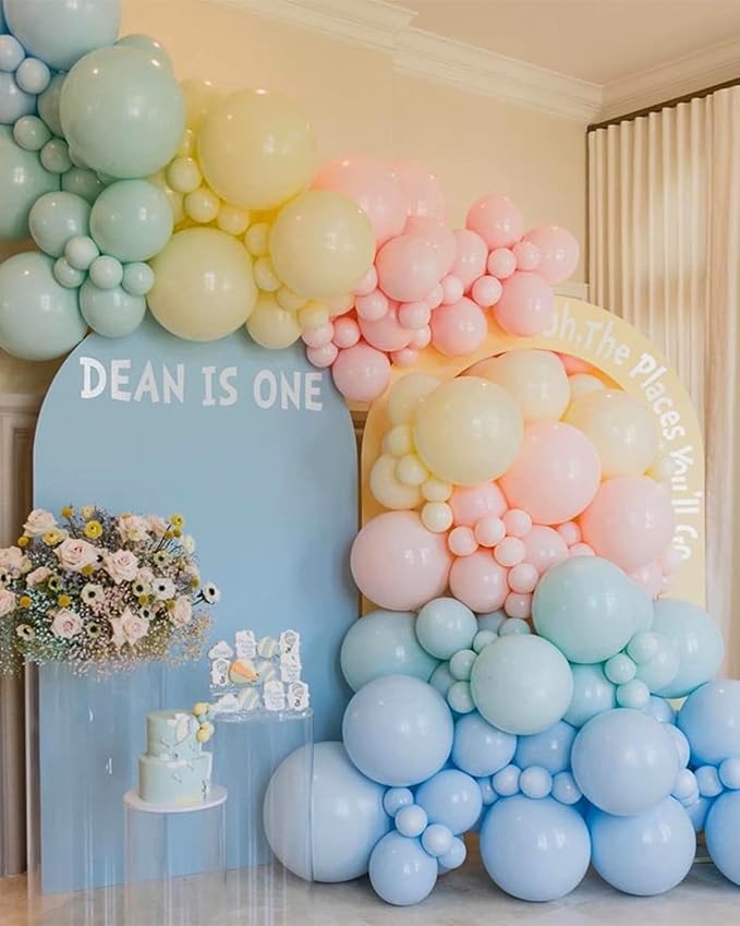 Pastel balloon arch garland with pale blue, pink, cream, and sage balloon clusters