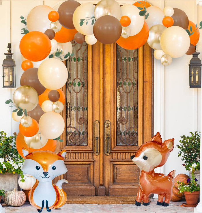 Woodland pumpkin balloon garland with fox and deer character balloons in orange and brown