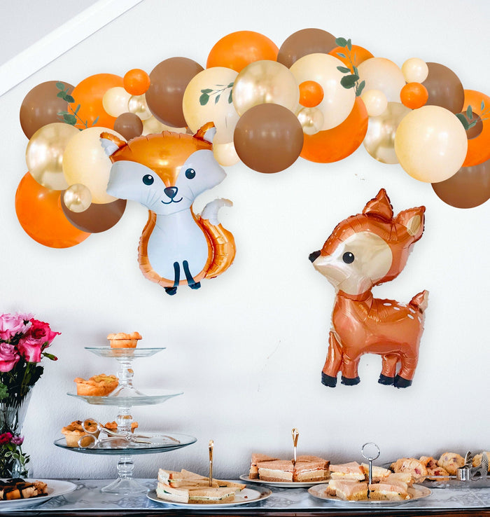 Woodland pumpkin balloon garland with fox and deer balloons and multicolor balloon arch