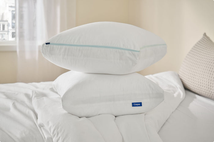 Two Original Cooling Pillows stacked on top of each other on a bed